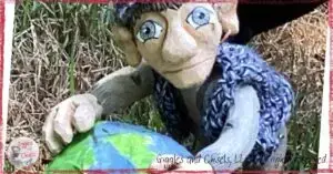 A wooden puppet, holding the earth