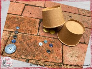 A picture with five buttons in a row, four buttons displayed randomly, and two yellow buttons under a paper cup.