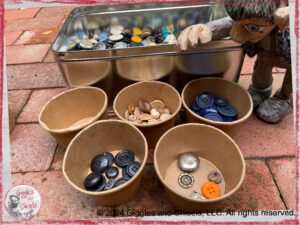 Maurice, a wooden puppet in the grey tone, sorting buttons by colors