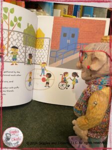 Madame Rigolotte, a wooden puppet, reading the book School's first day of school