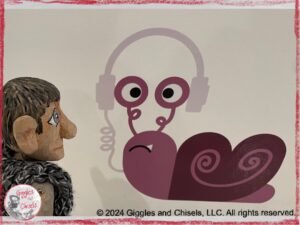 Maurice, a wooden puppet in gray shades, looking at a painting of a snail with headphones
