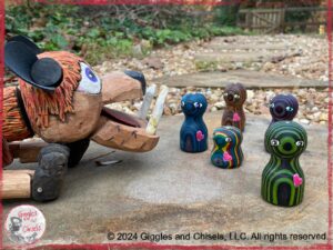 A mystical wooden puppet, looking at little creatures, turned on a lathe, with a heart painted on them.