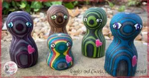 A picture of five Pouilles, little wooden characters spreading love around them