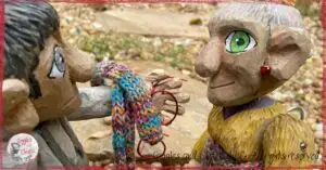 Maurice, a wooden puppet, caring for Mme Rigolotte, another wooden puppet