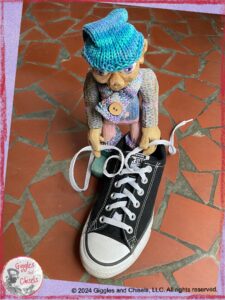 Petite Clothilde, a wooden puppet, practicing how to tie shoes