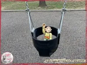 A picture of Pierre Qui Roule's hand, a wooden puppet, on a swing