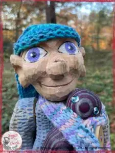 Petite Clothilde, a wooden puppet in blue and purple shades