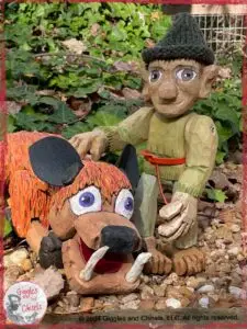 Pierre-Qui-Roule, a wooden puppet, next to a mystical creature, also made out of wood