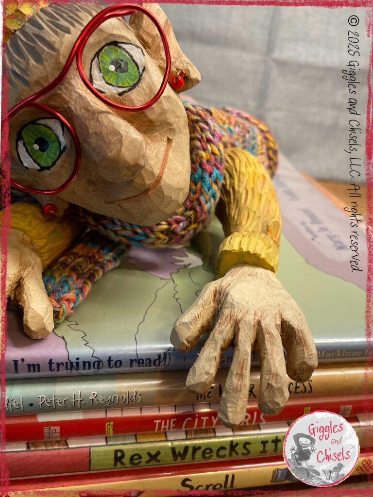 A picture of Mme Rigolotte, a wooden puppet, on a pile of picturebooks