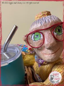 A picture of Mme Rigolotte, a wooden puppet, holding her favorite cup