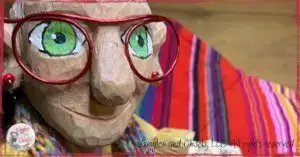 A picture of Mme Rigolotte, a wooden puppet, holding a colorful piece of fabric