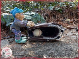 Petite Clothilde, a wooden puppet, finding a baseball glove