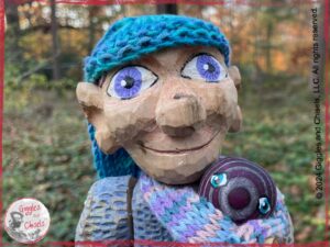 Petite Clothilde, a wooden puppet in blue and purple shades