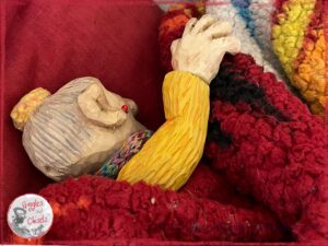 Mme Rigolotte, a wooden puppet, taking a nap