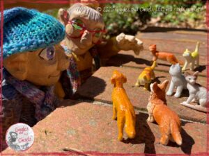 Mme Rigolotte and Petite Clothilde, two wooden puppets, inventing stories about dogs and cats.
