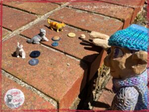Petite Clothilde, a wooden puppet, inventing a story about cats and buttons.