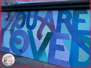 A mural, with the words "You are loved" on it