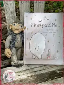 Maurice, a wooden puppet, in front of the book, Empty and Me