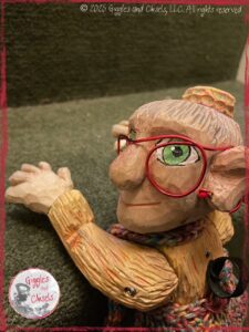 Mme Rigolotte, a wooden puppet, crawling down few steps