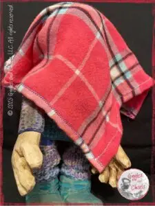 Petite Clothilde, a wooden puppet, hidden under her favorite piece of cloth