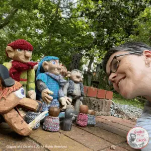Four wooden puppet and a human being smiling at them