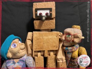 Petite Clothile and Mme Rigolotte, two wooden puppets, next to a wooden robot