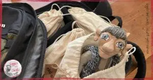 Maurice, a wooden puppet, in a backpack, ready to travel