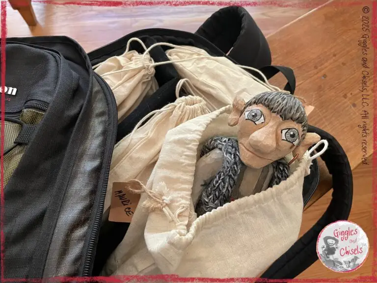 Maurice, a wooden puppet, in a backpack, ready to travel