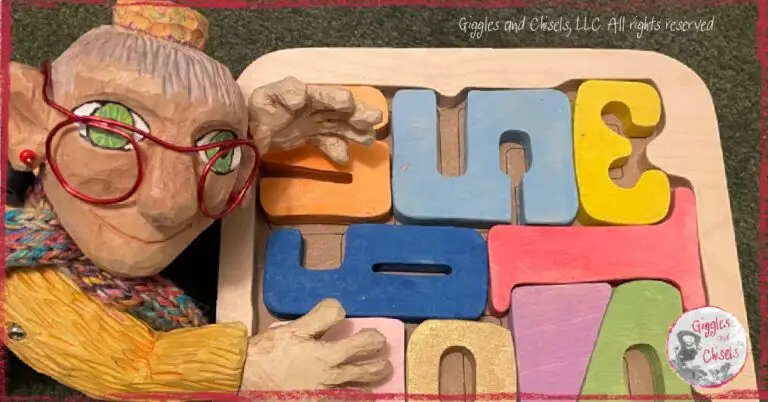 Mme Rigolotte, a wooden puppet, in front of a puzzle