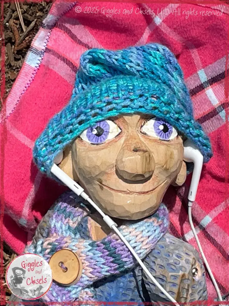 Petite Clothilde, a wooden puppet, listening to music