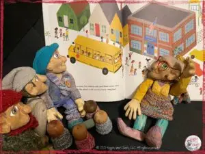 Mme Rigolotte, a wooden puppet, reading a picturebook