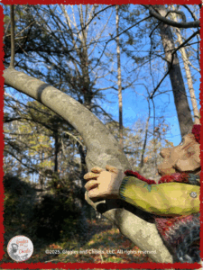 A wooden puppet climbing up a tree
