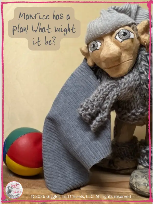 Maurice, a wooden puppet, in front of a set of juggling balls while holding a piece of grey fabric