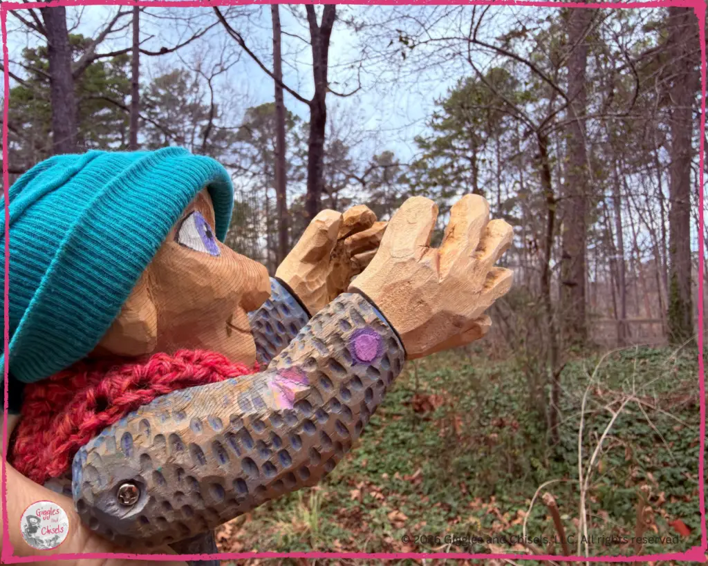 Petite Clothilde, a wooden puppet, reaching for the stars