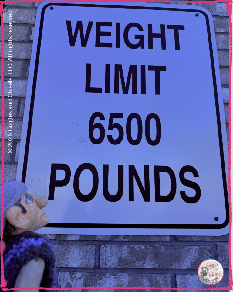 Maurice a wooden puppet, in front of asign Weight Limit 6500 pounds