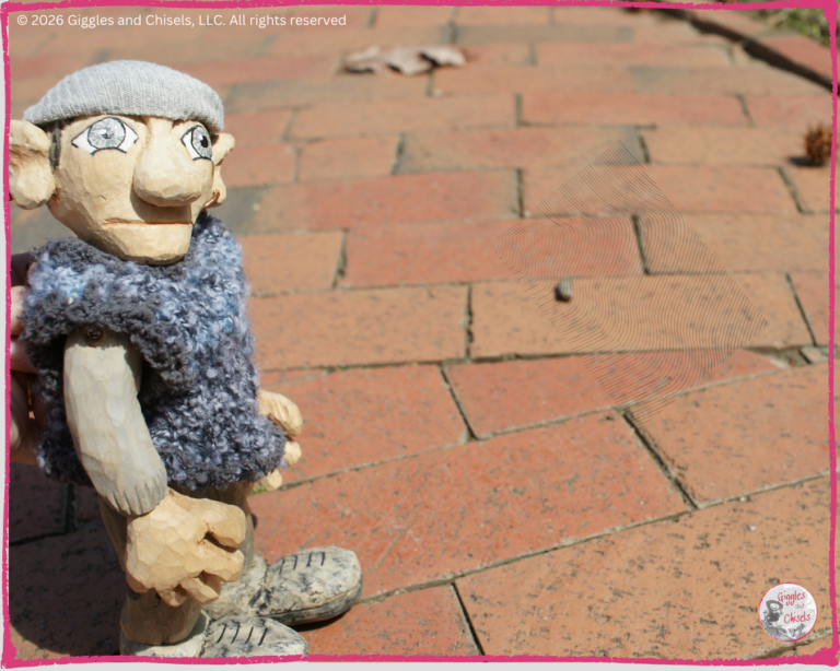 Maurice, a wooden puppet, looking at a paved sidewalk