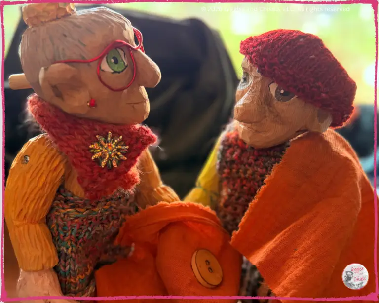 Mme Rigolotte, and Pierre Qui Roule, two wooden puppets, taking some measurement of a shirt