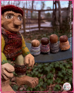 Pierre Qui Roule, a wooden puppet, seating on a swing with some whimsical creatures