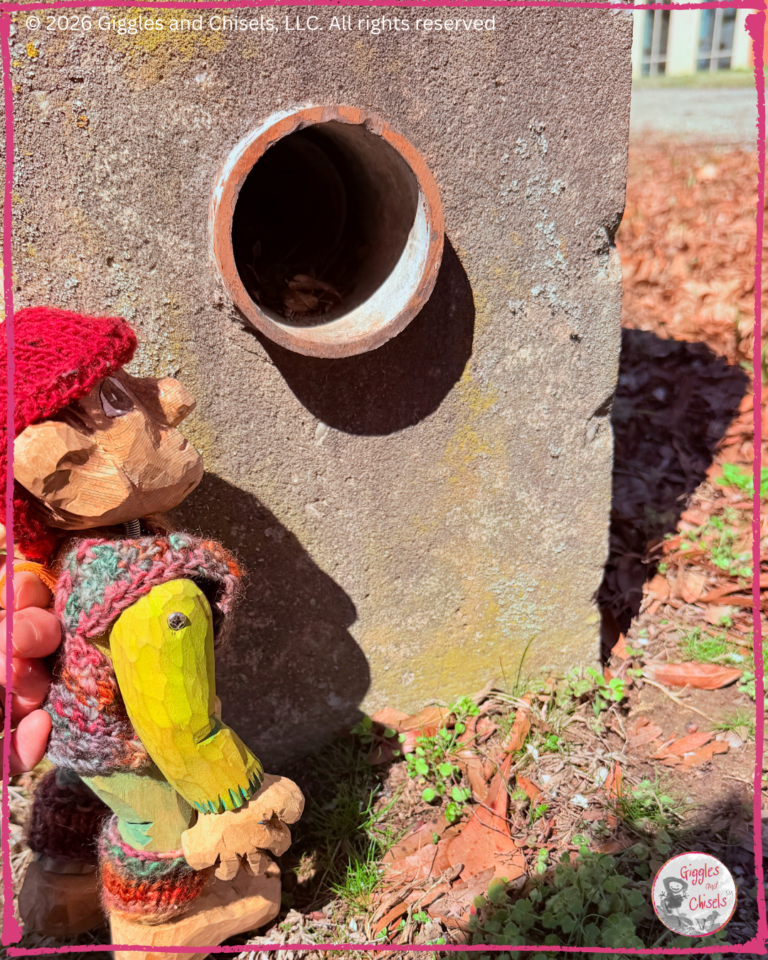 Pierre Qui ROule, a wooden puppet, in front of a pipe