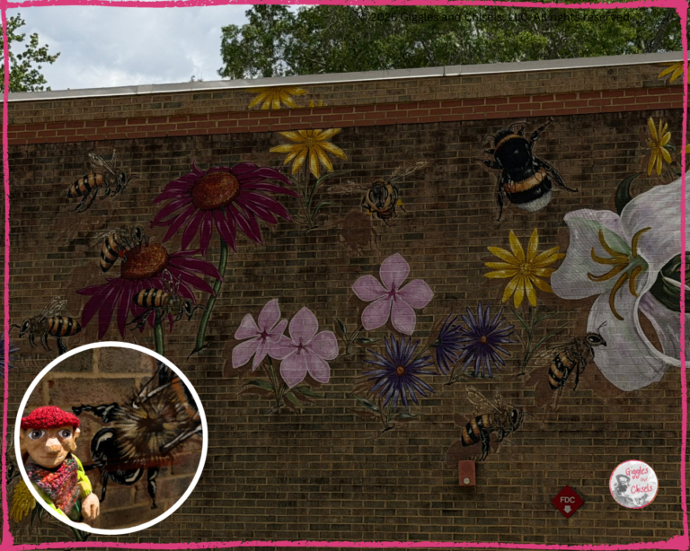 Pierre Qui Roule, a wooden puppet, in front of Honey Bee Mural, by Matthew Willey.