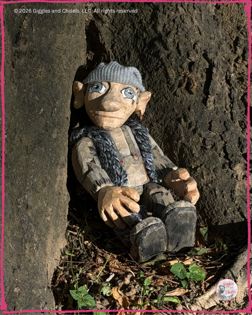 Maurice, a wooden Fellow, resting against a tree