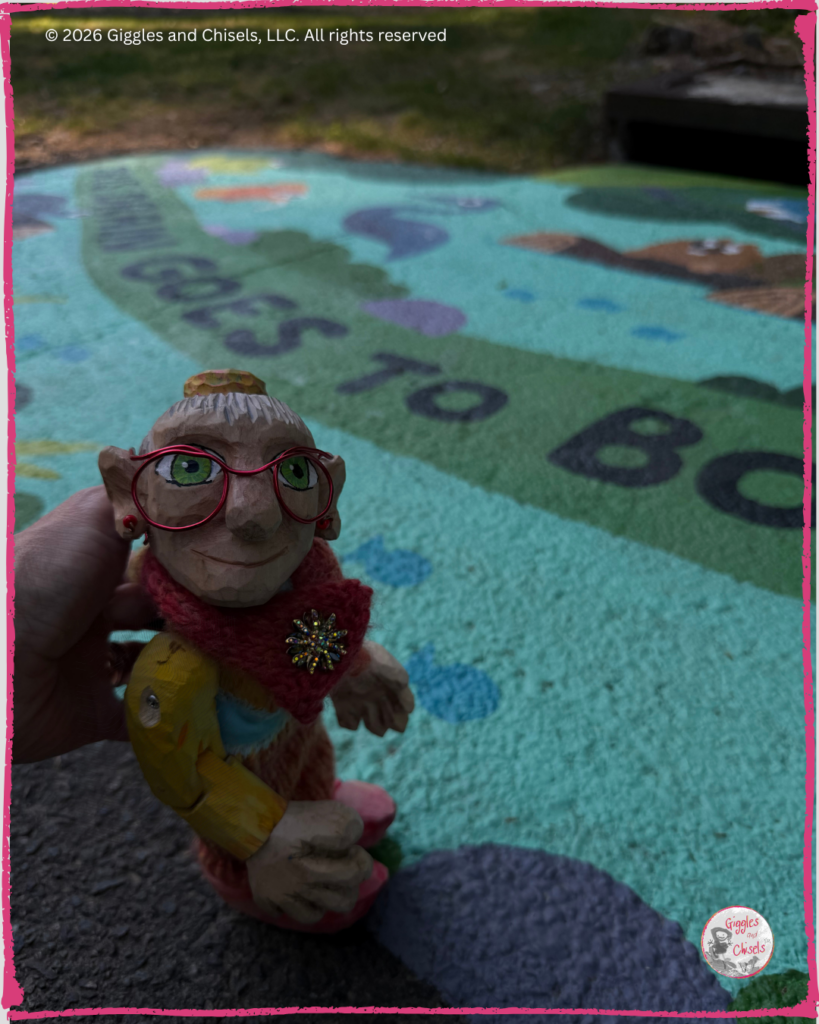 Mme Rigolotte, a wooden Fellow, looking at a stormwater mural