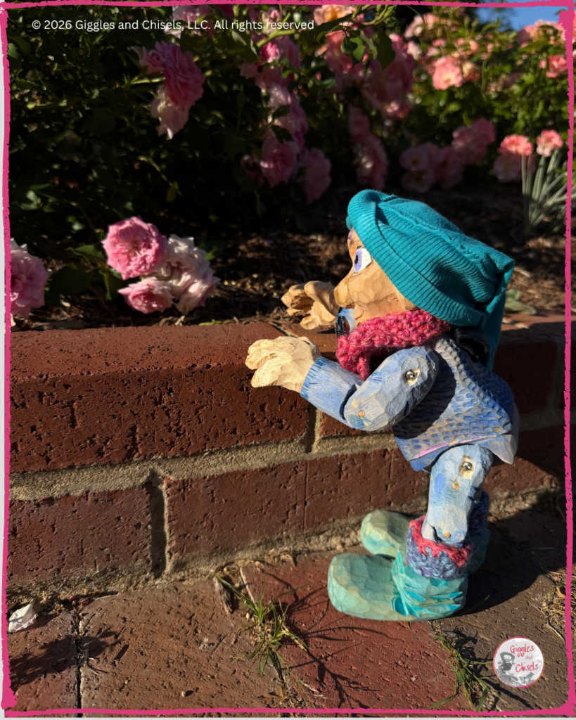 Petite Clothilde, a wooden Fellow, talking to a rose