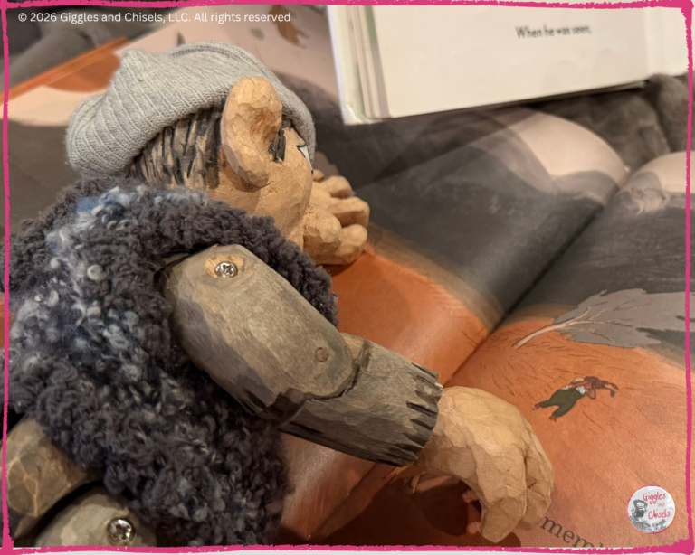 A wooden puppet, looking at a picturebook