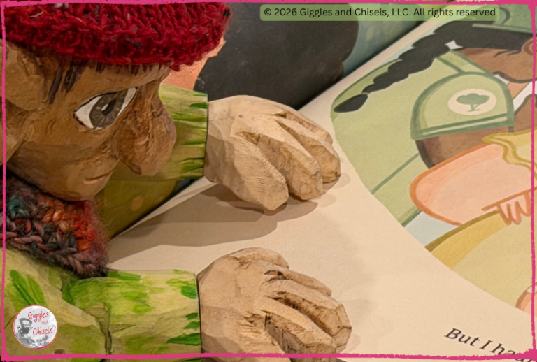 A wooden puppet, looking at a picturebook