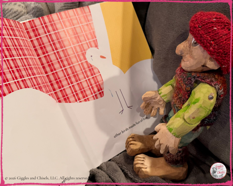 A wooden puppet, looking at a picturebook